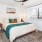 a bedroom with a bed and large windows 