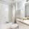 a bathroom with a shower, sink and tub