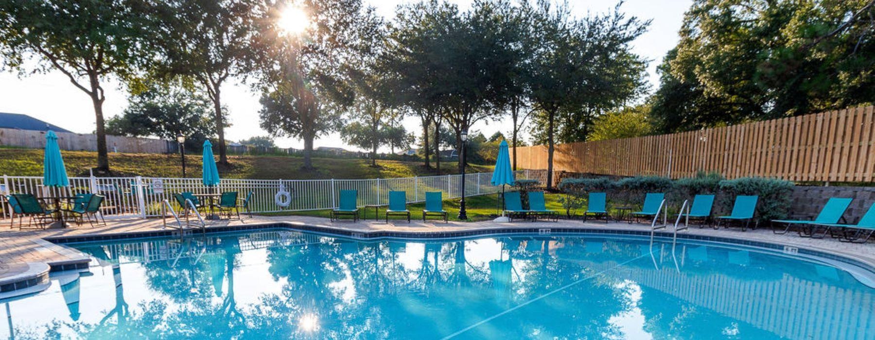 a swimming pool with chairs around it