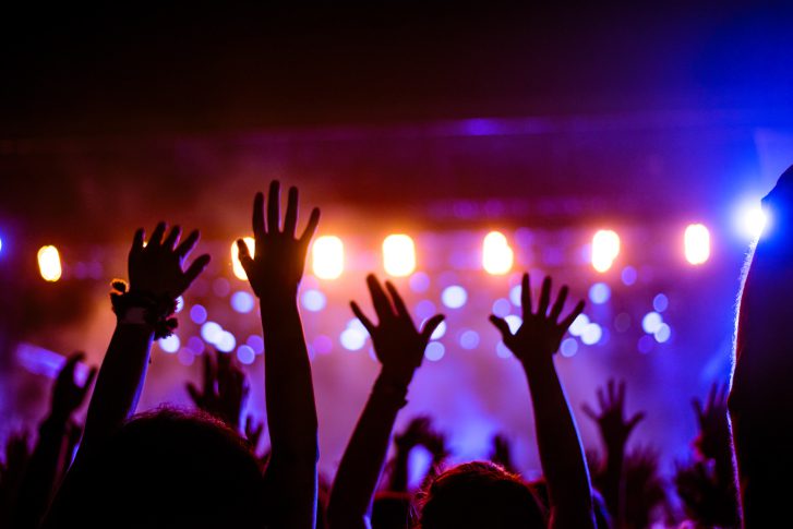 hands raised at a concert