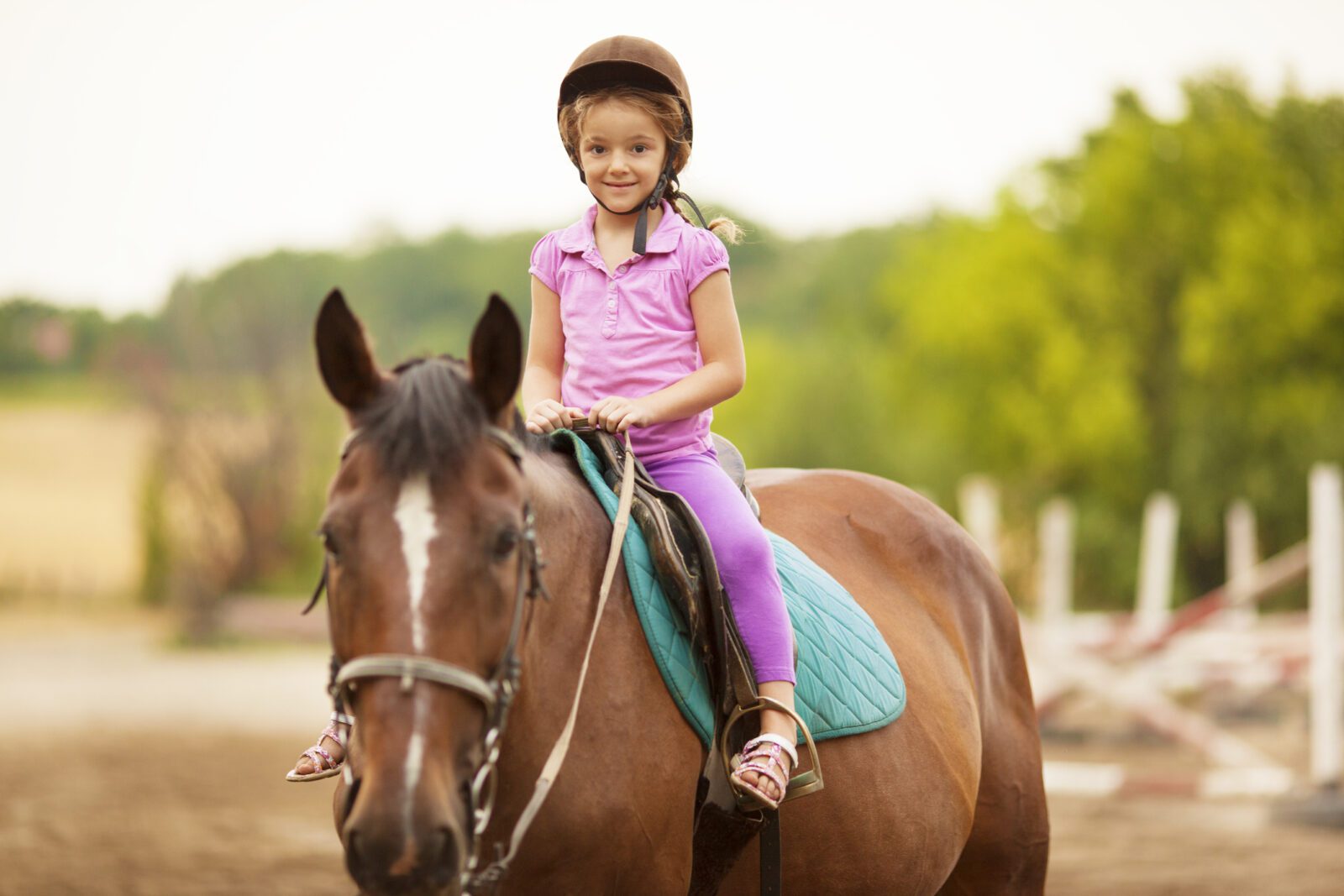 Child Riding Horse Outdoors.
