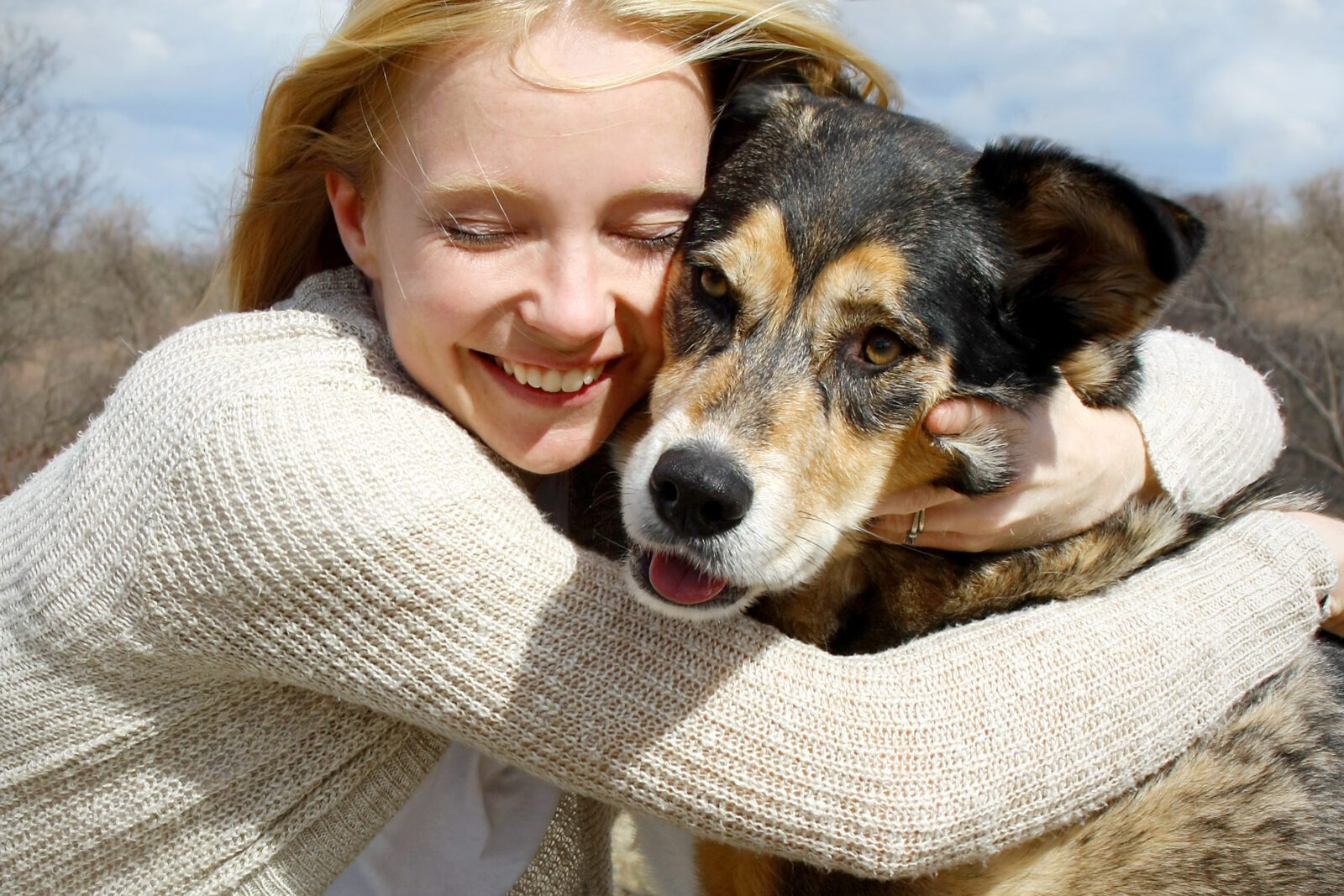 Close up of Woman Hugging German Shepherd Dog