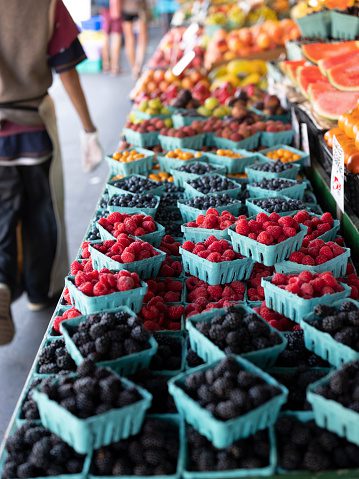 Fresh organic raspberries on stall for sell in marketplace